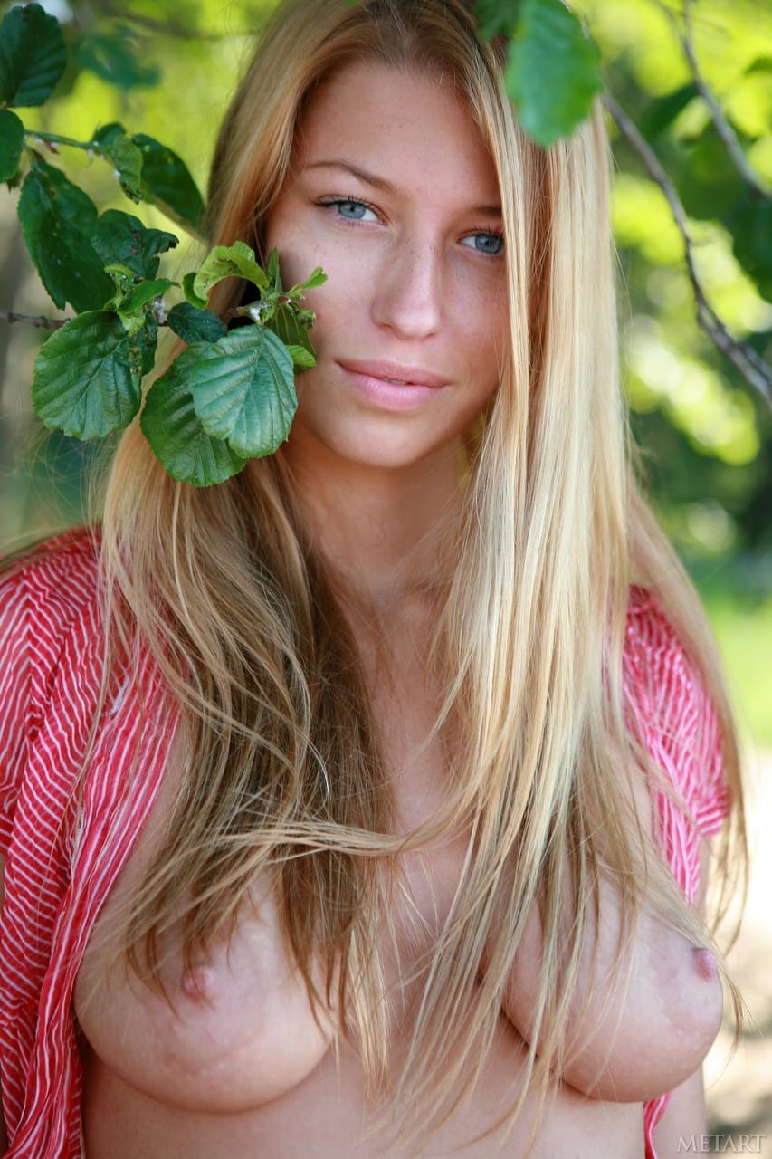 Yana P szőke szépsége a tengerparton, csodás mellekkel és lenyűgöző pózokkal.