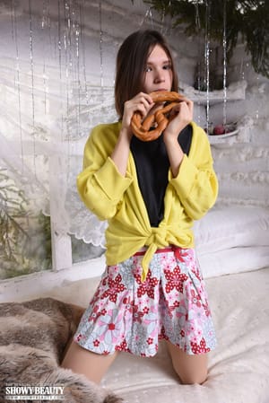 Sweet teen Loli uncovers her perky tits before pulling down her skirt